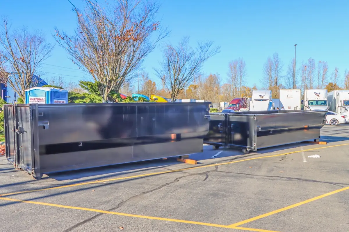 Professional dumpster rental service with roll-off container on residential driveway in Pike Creek